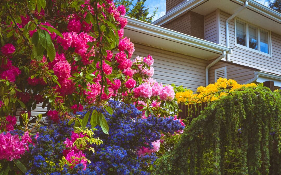 A flower-filled garden in front of a house.